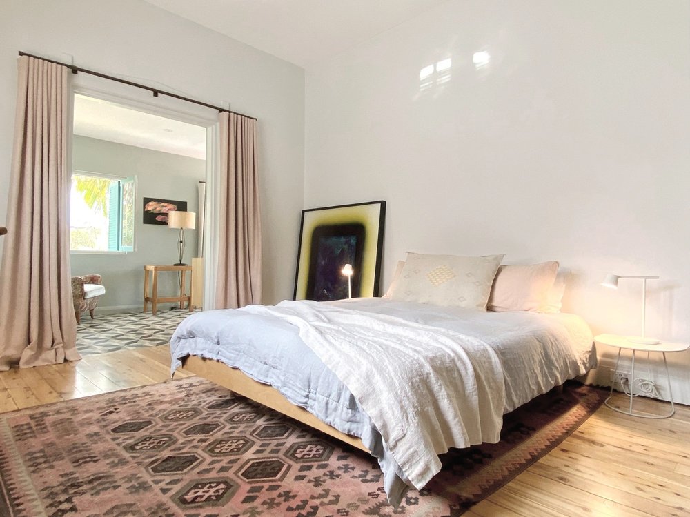 Styled bedroom with a Peace Lily bed at the Bondi Beach House accommodation